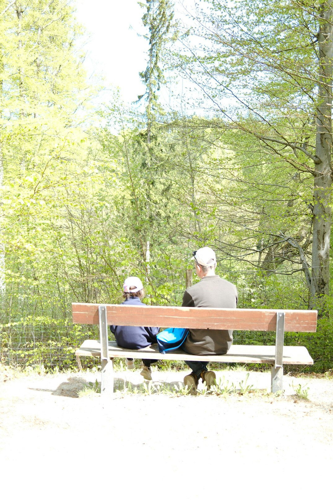 Two people having a candid conversation on a park bench