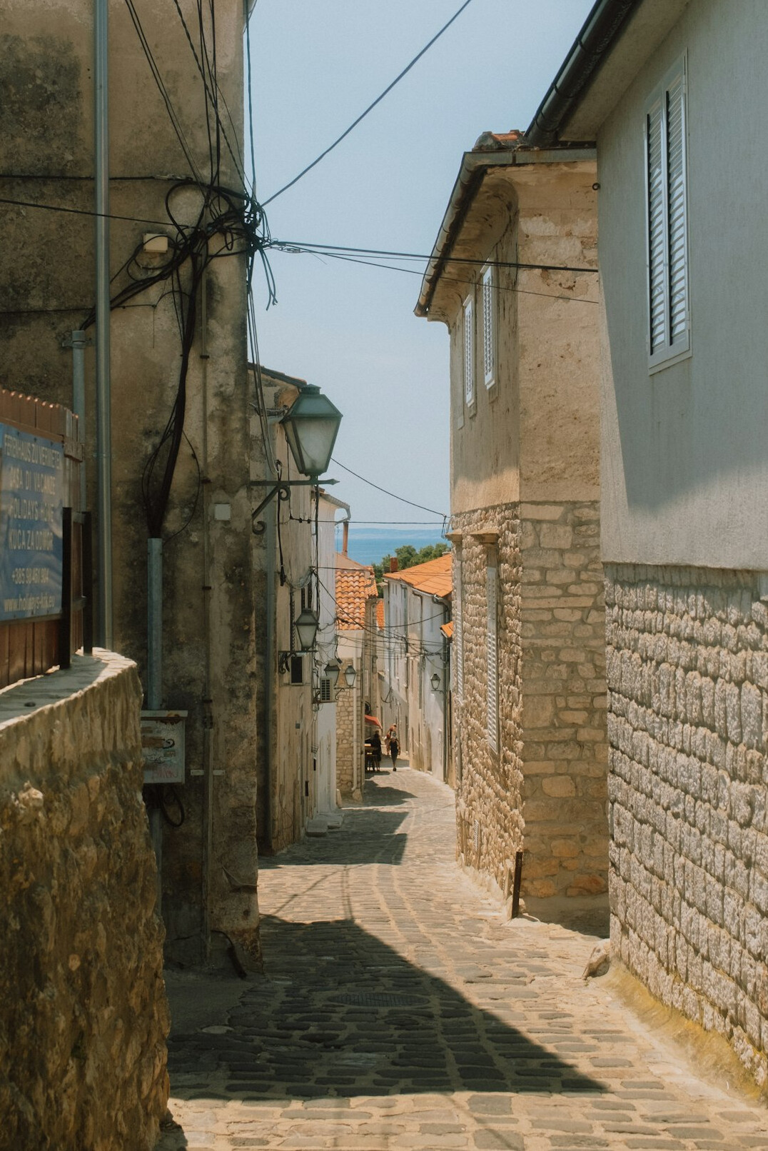 Narrow laneway between brick buildings in an old city quarter